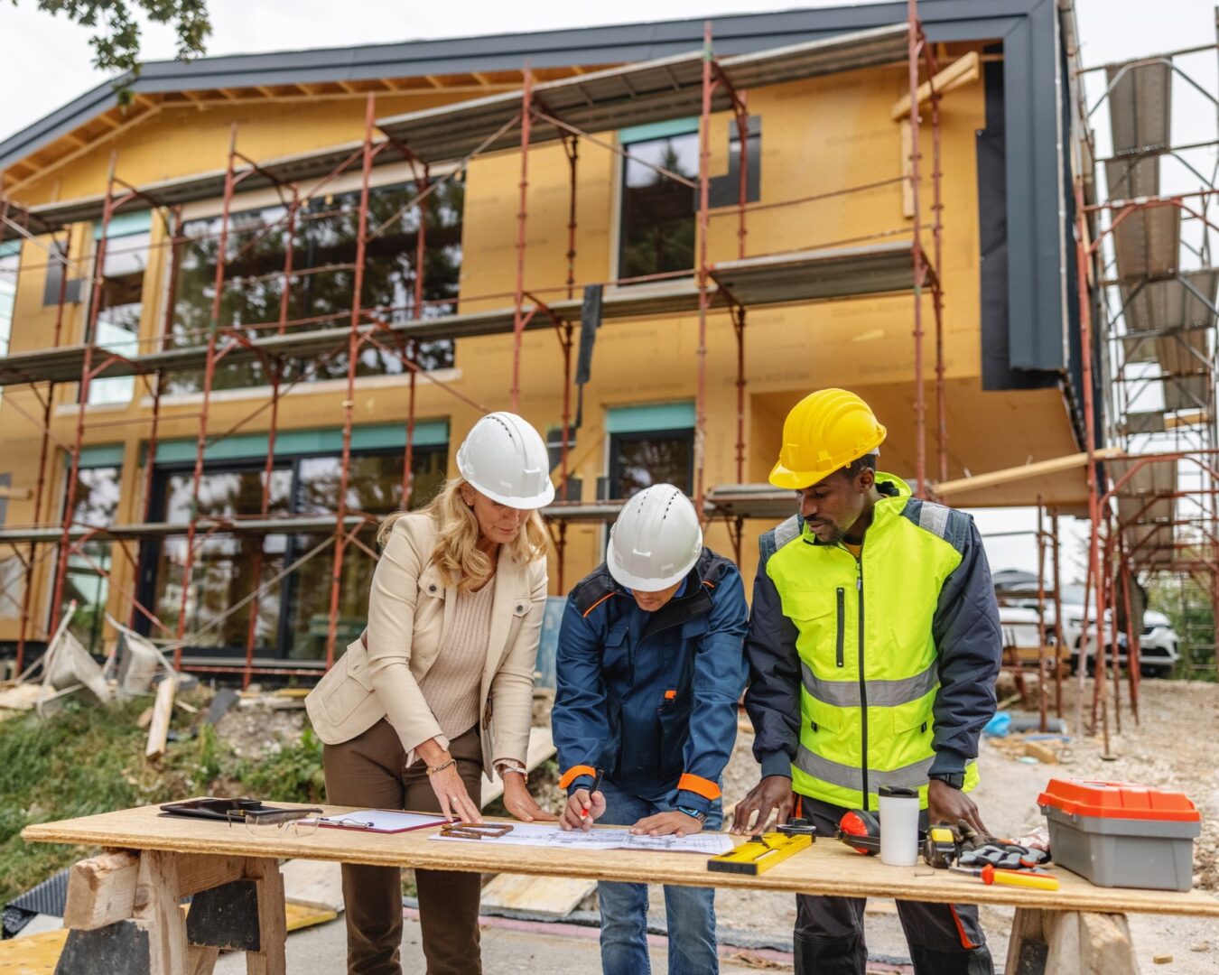 Workers collaborating on house construction