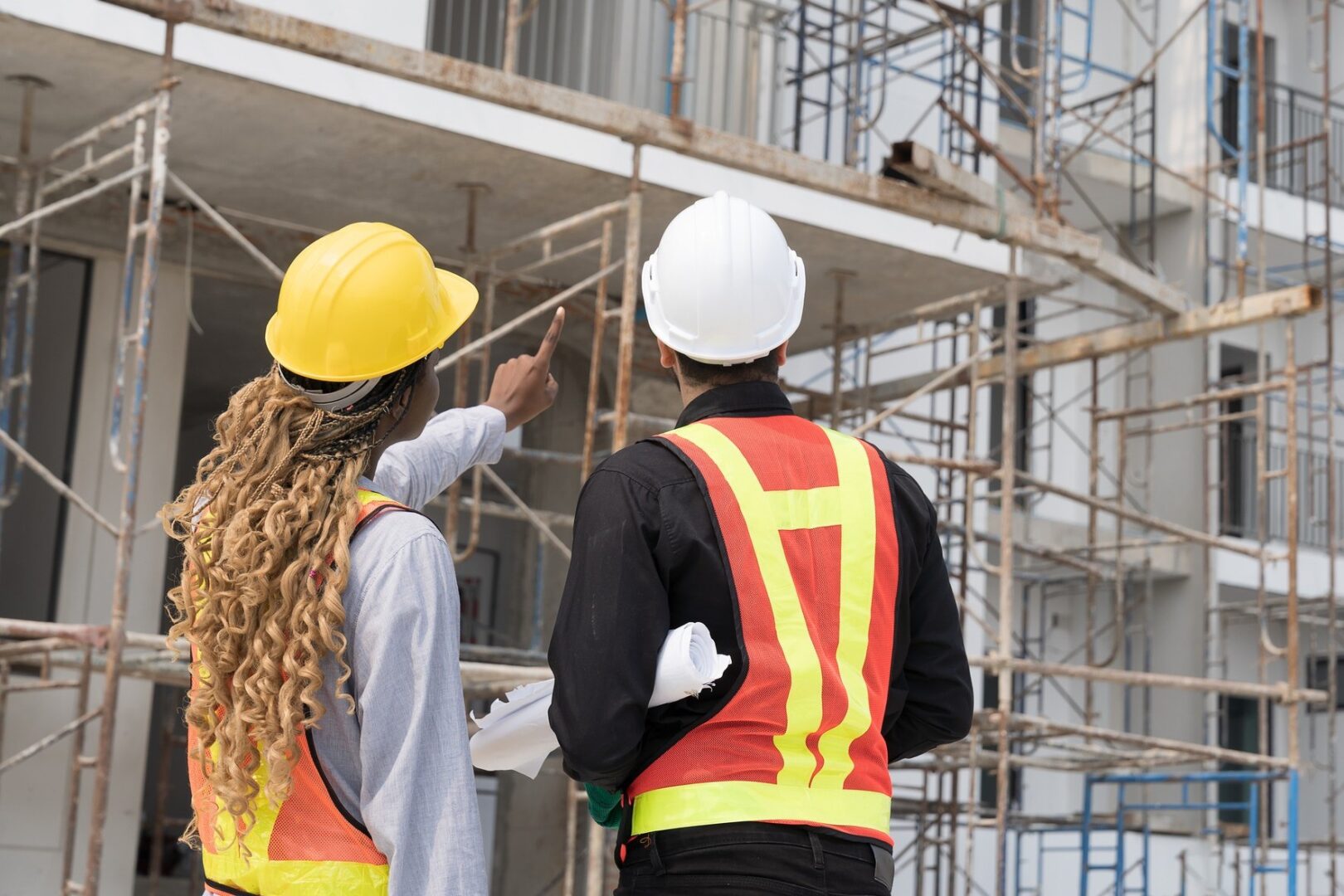 Construction workers inspecting building site