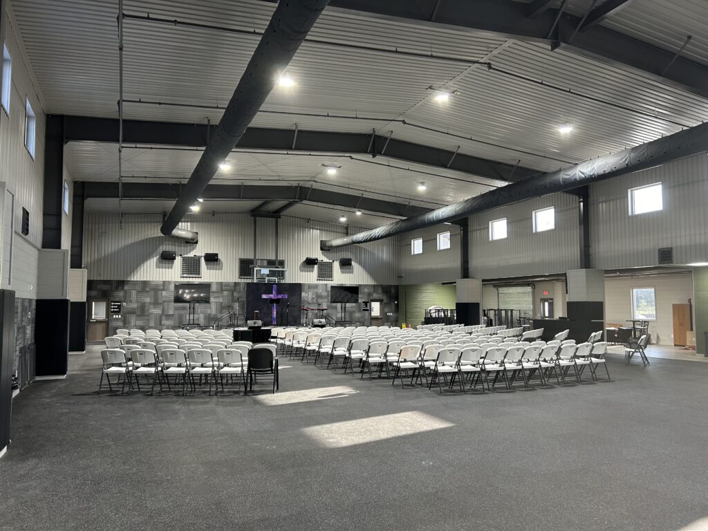 Indoor venue with arranged white chairs