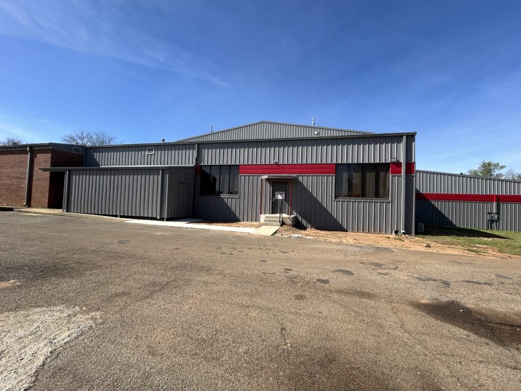 Gray metal industrial building under blue sky